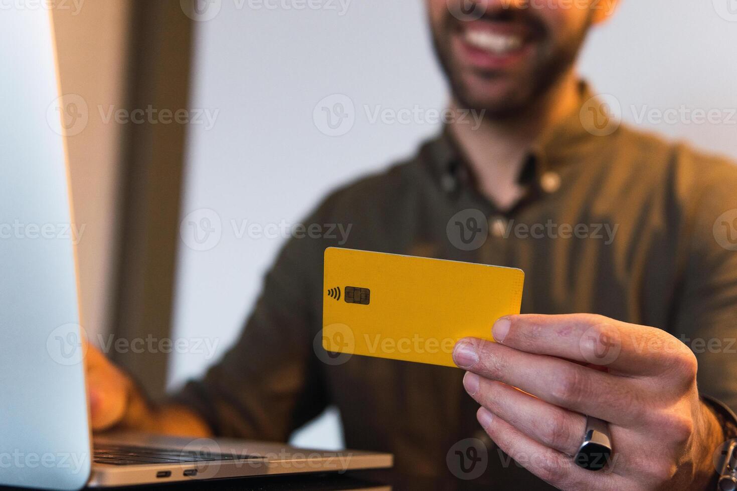 Anonymous man with credit card shopping online photo