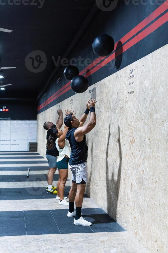 Hispanic sportspeople training with medical balls photo