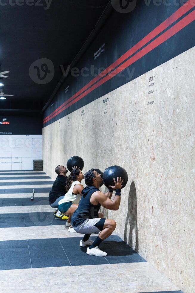 Hispanic sportspeople training with medical balls photo