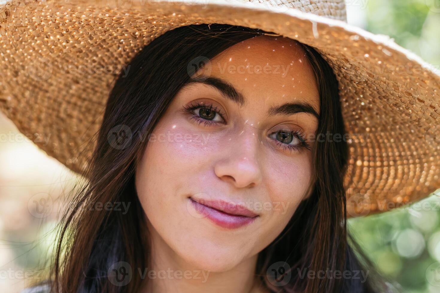Woman with a straw hat in the forest photo