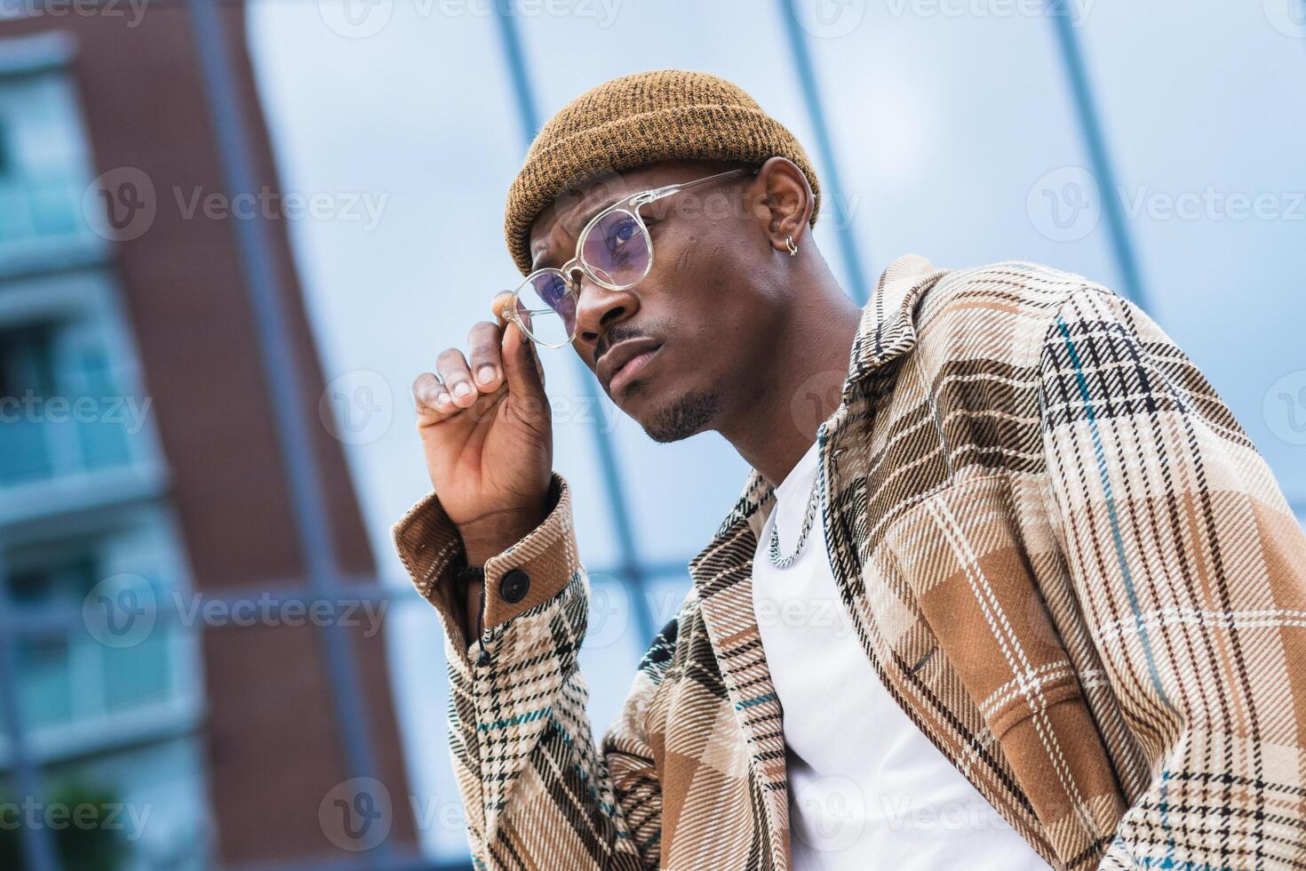 Stylish African American man resting on street photo