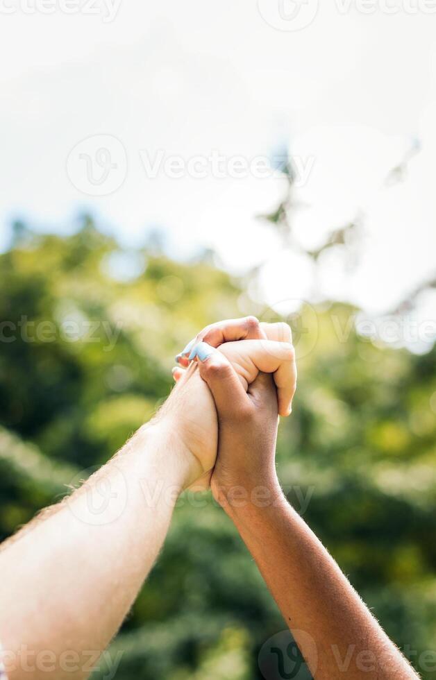 Interracial couple taking a walk hand in hand in the park photo