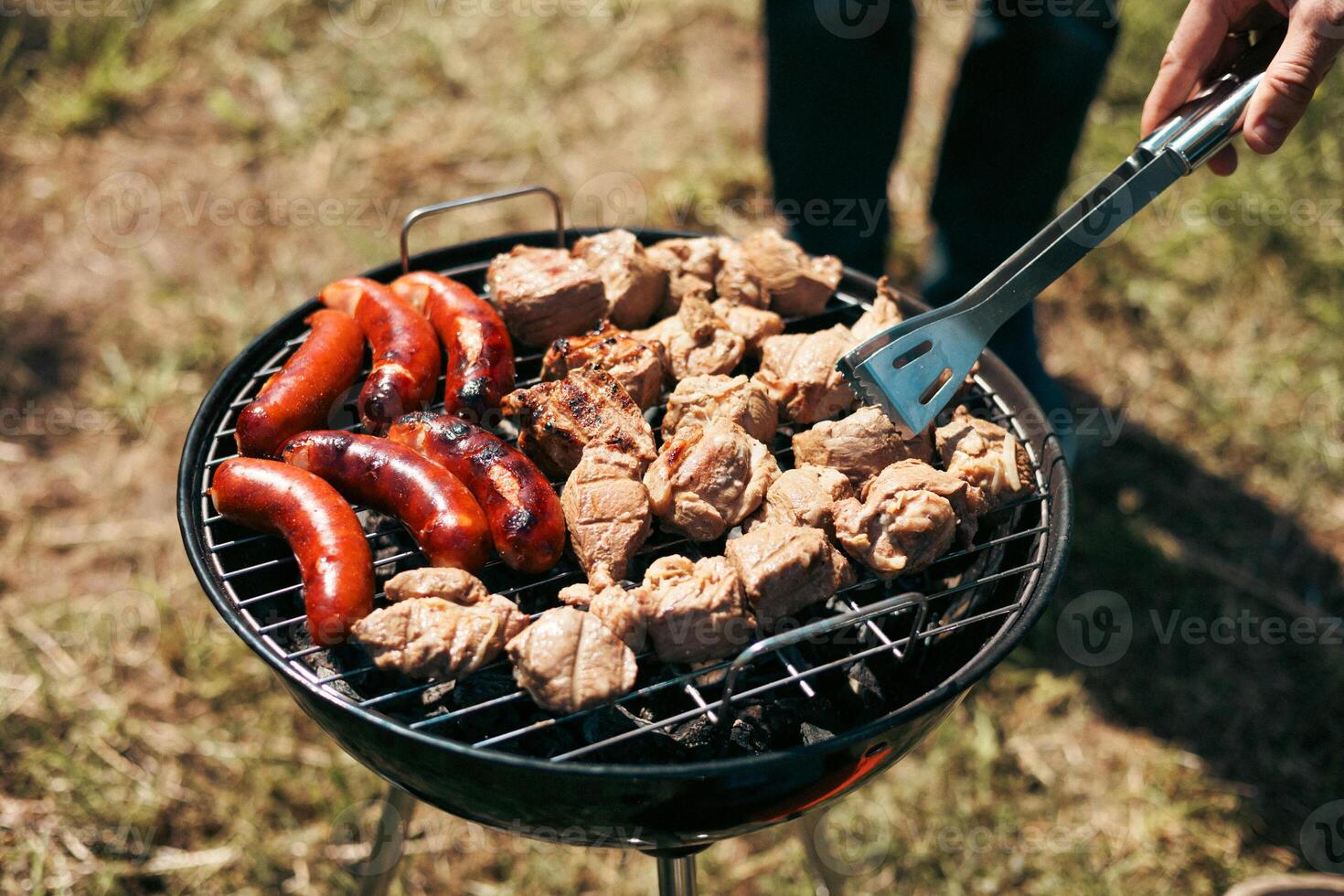 Meat is fried on a campfire, barbecue in nature. Pickled meat is cooked on coals, Grilled BBQ. photo