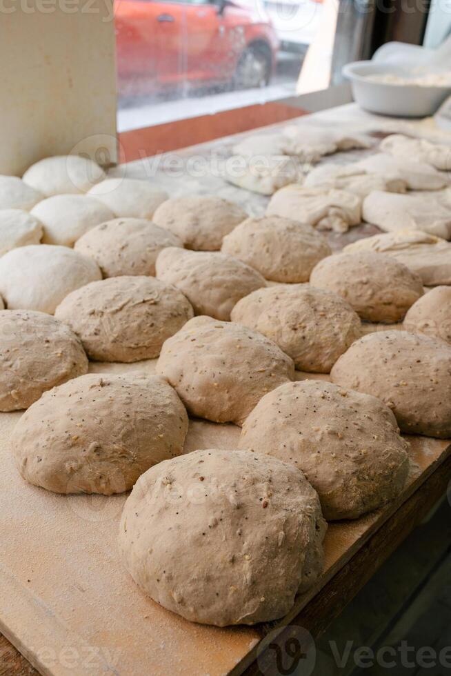 Loaf-shaped bread dough on the table photo