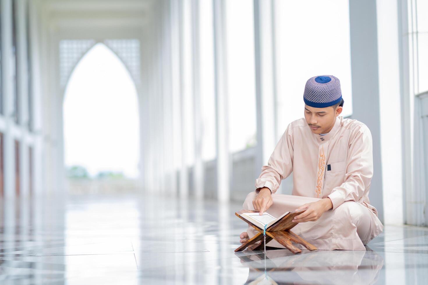 Asian Muslim man is sitting and reading the Quran. photo