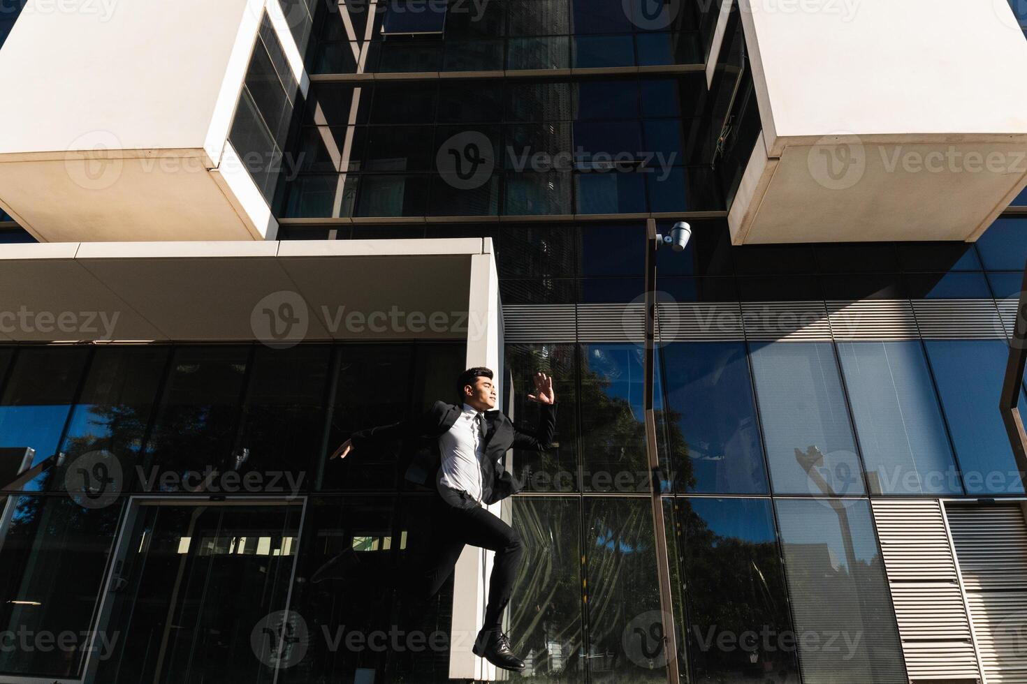 A man in a suit jumping in the air photo
