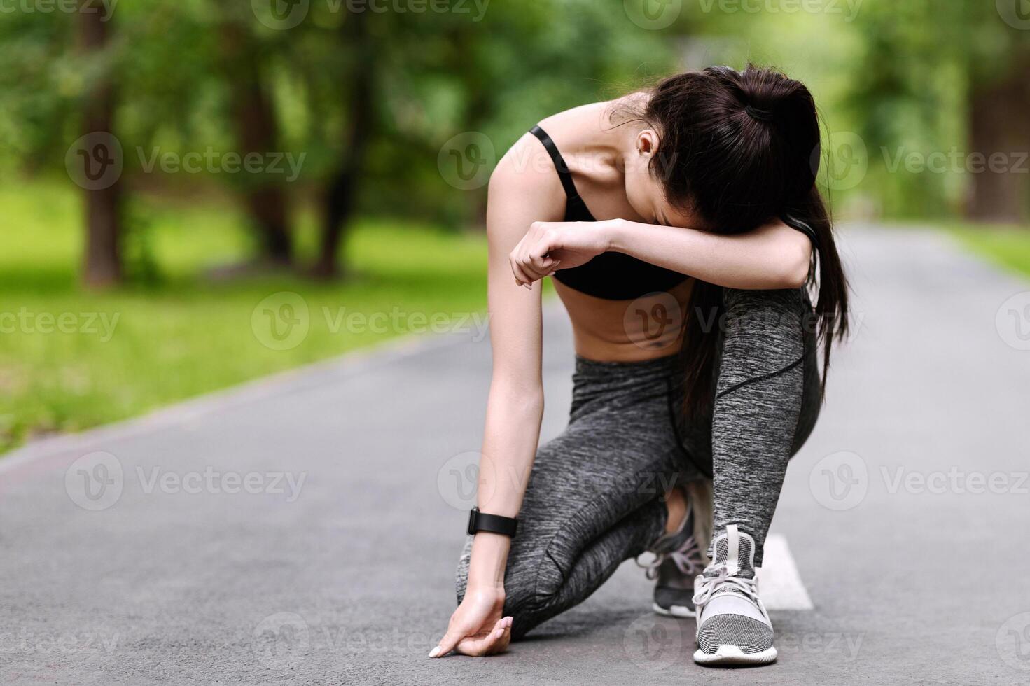 Exhausted Asian Jogger Girl Resting On Path In Park After Long Run, Taking Breath And Relaxing, Copy Space photo