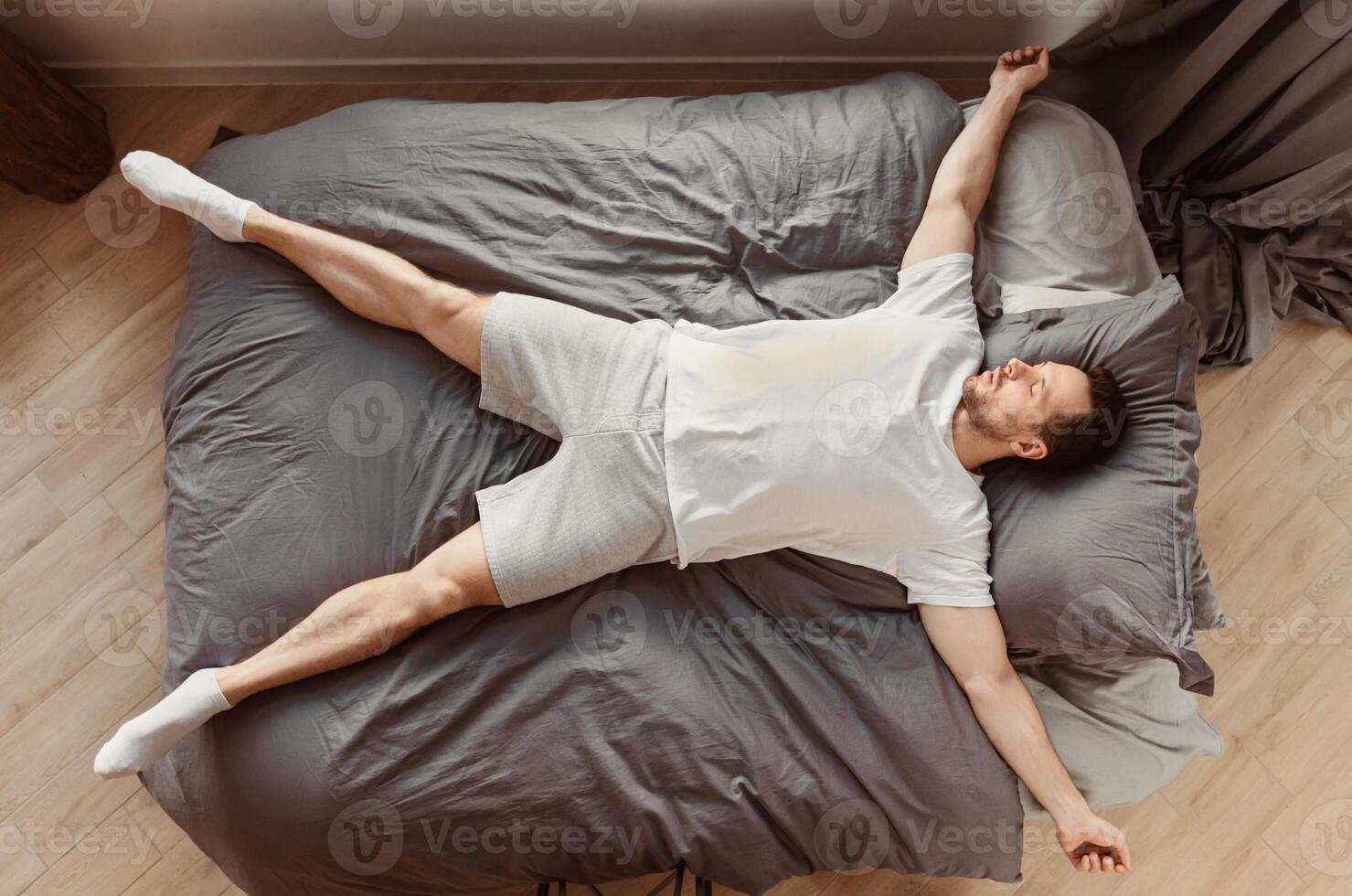 Fast Asleep Man Sleeping Lying On His Back In Bed Resting At Home. Healthy Sleep Concept. Top View photo