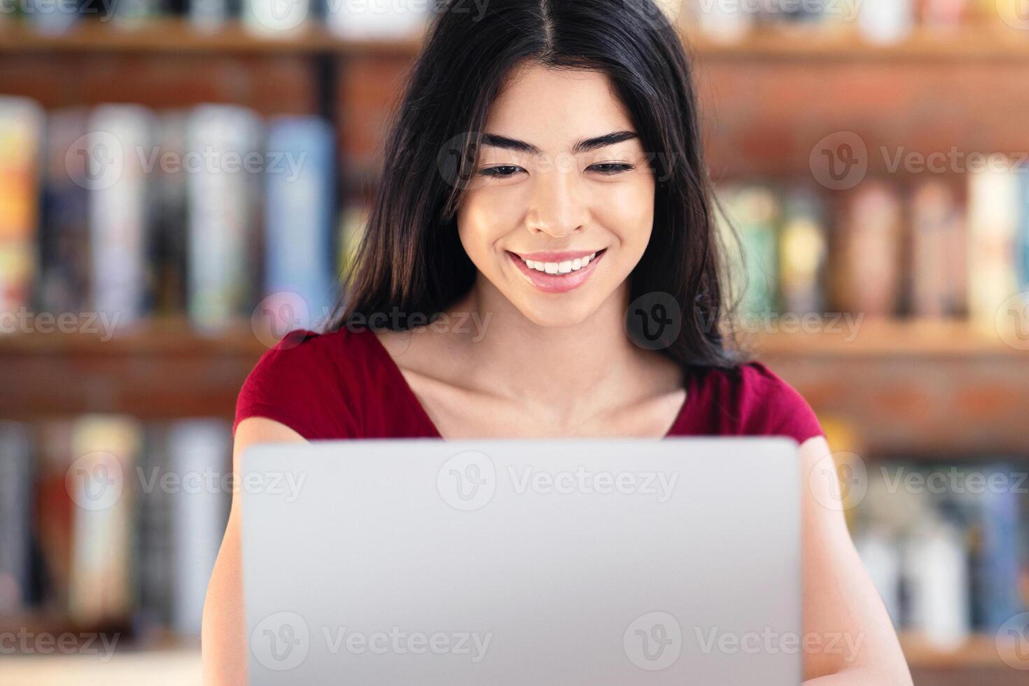 Working Online Concept. Smiling Asian Girl Freelancer Using Laptop In Cafe, Looking At Device Screen, Free Space photo