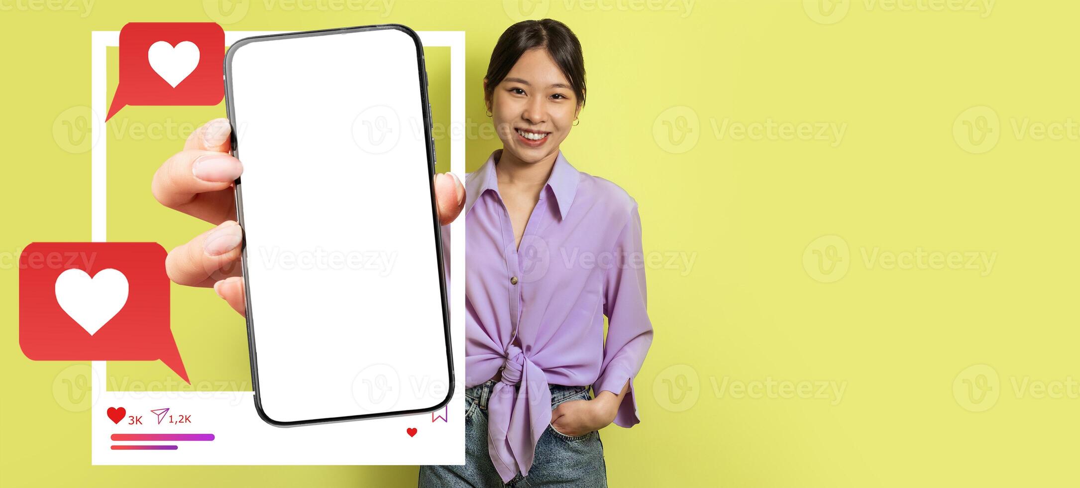 An influencer stands against a bright yellow background, holding a smartphone with a blank screen, highlighting social media interaction through likes and messages. The setting is lively and modern. photo