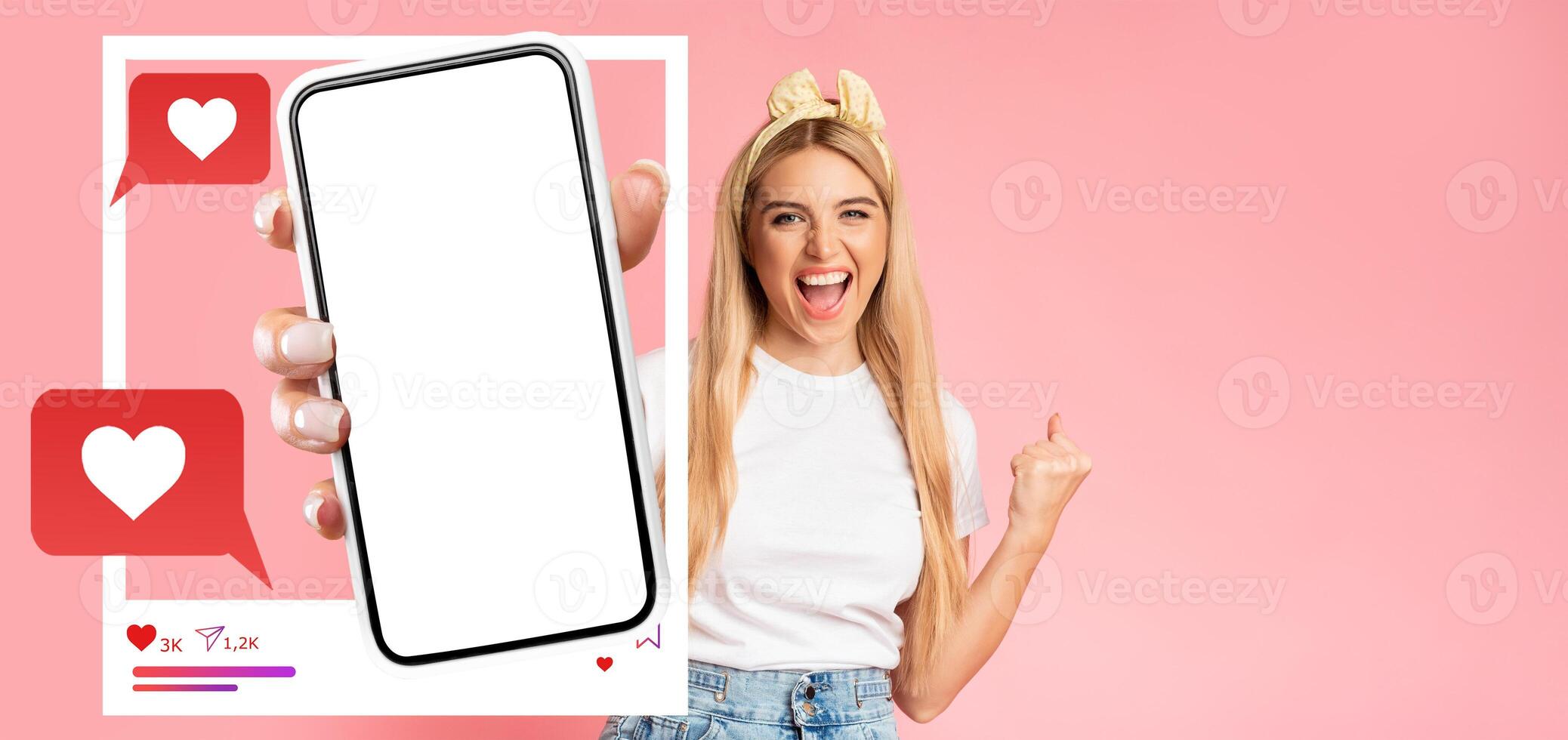 An influencer enthusiastically holds a smartphone with a blank screen, celebrating social media interactions. Bright pink background enhances the lively atmosphere, perfect for digital content. photo