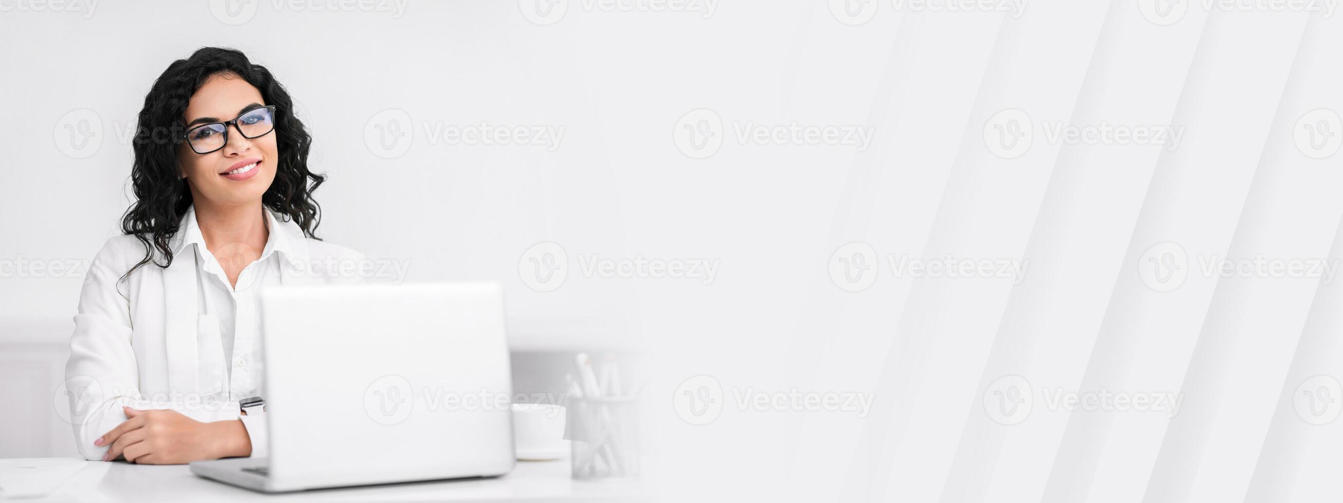 Successful Businesswoman. Portrait of confident mexican lady sitting at desk, looking at camera, copy space photo