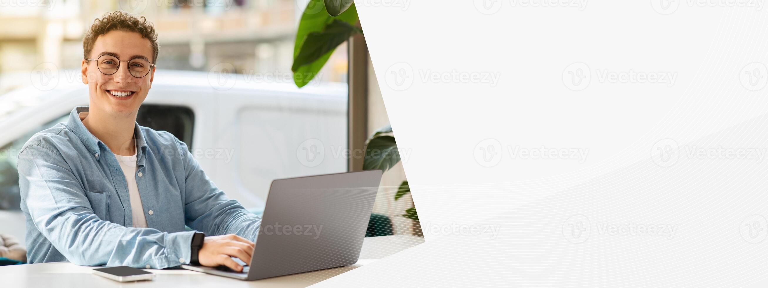 Smiling proud millennial european guy student in glasses, typing on computer, work, study online, chatting in cafe. Online meeting, lifestyle remotely, digital nomad, freelance photo