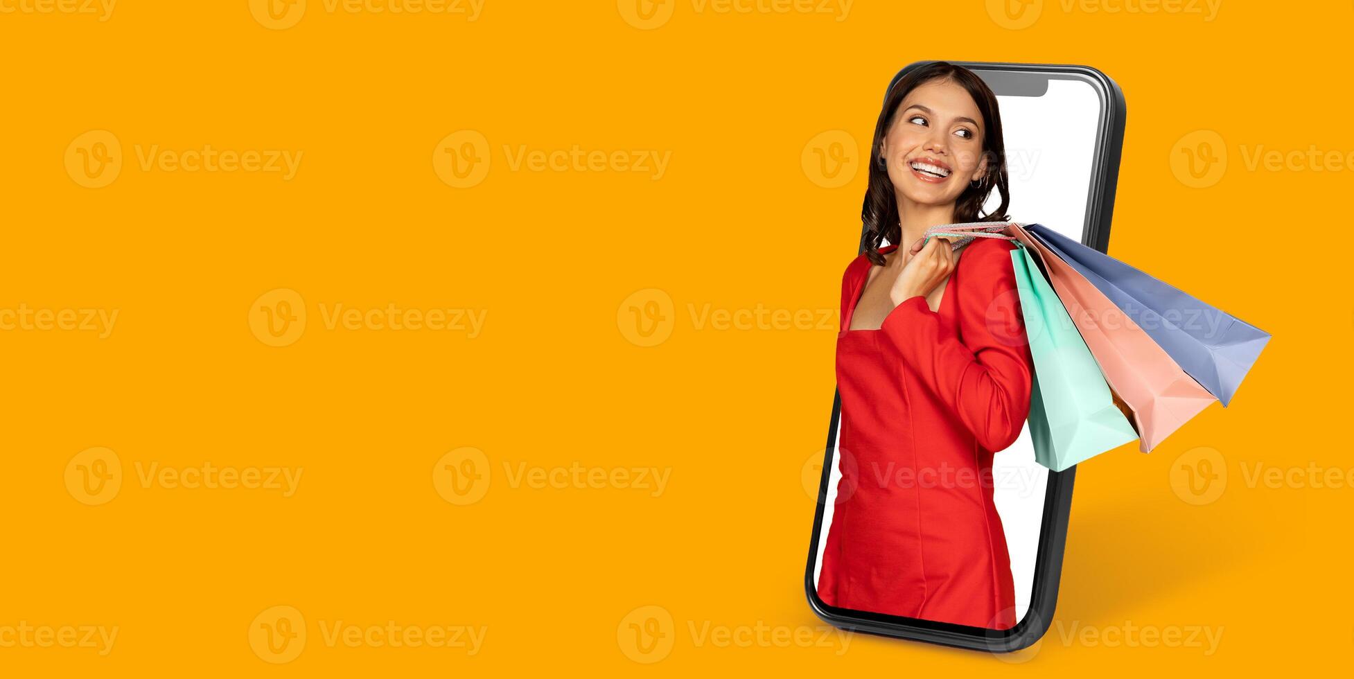 A happy customer engaged in online shopping uses a smartphone to browse through products while displaying colorful shopping bags, illustrating the modern consumer experience in e-commerce. photo