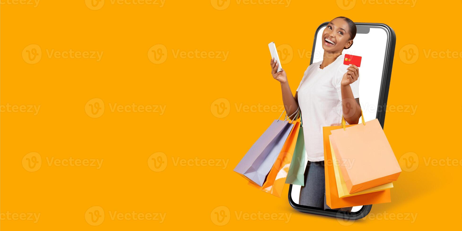 A joyful customer enjoys online shopping on a smartphone, holding a credit card and shopping bags. This represents modern ecommerce and the convenience of mobile purchasing. photo