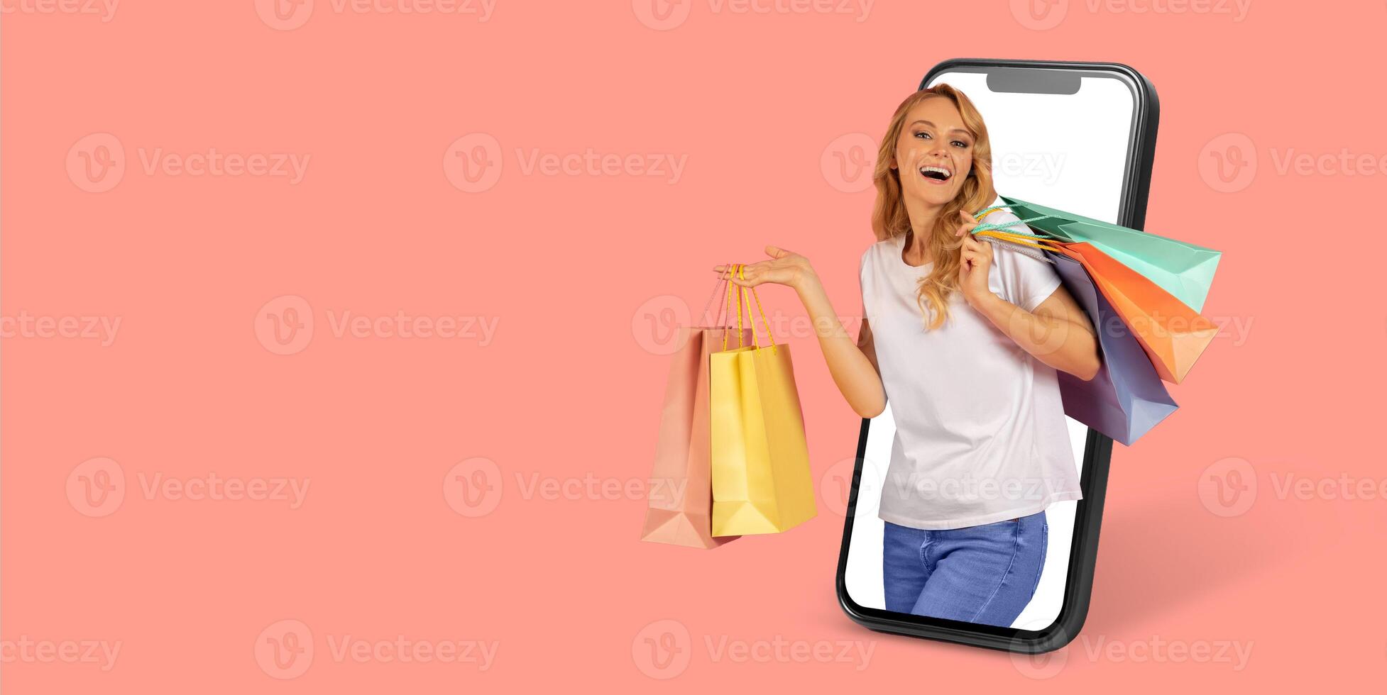 A joyful buyer holding shopping bags stands inside a smartphone display, showcasing the convenience of online shopping. The bright background emphasizes the excitement of e-commerce. photo