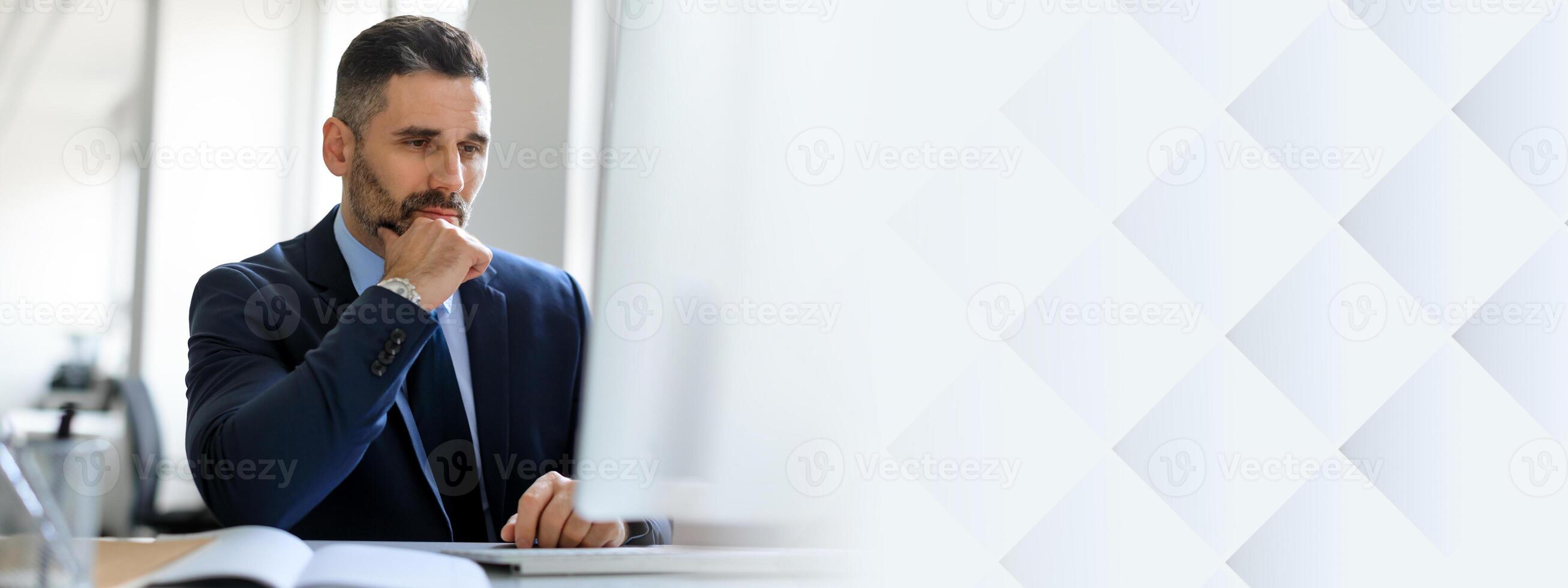 A middle aged businessman sits at his desk in an office, contemplating important decisions. The environment suggests professionalism and ambition, with an emphasis on success in his career, copy space photo