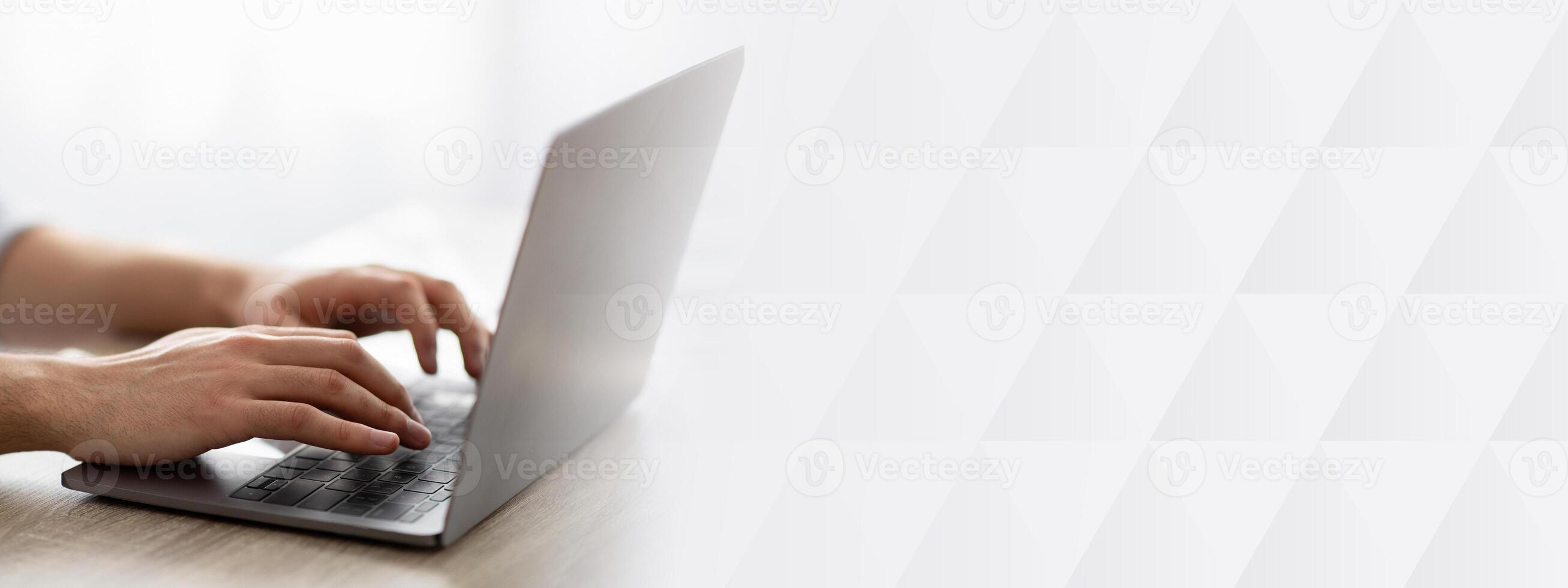 Working at laptop pc. Man typing text or programming code on computer, holding hands on laptop keyboard, closeup, crop. Unrecognizable guy working online at home office photo