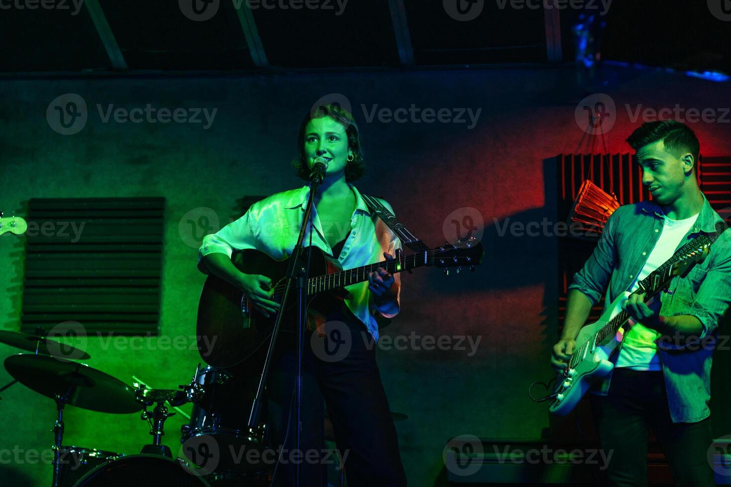 Musicians In Stage With Colorful Lights Performing In A Live Concert photo