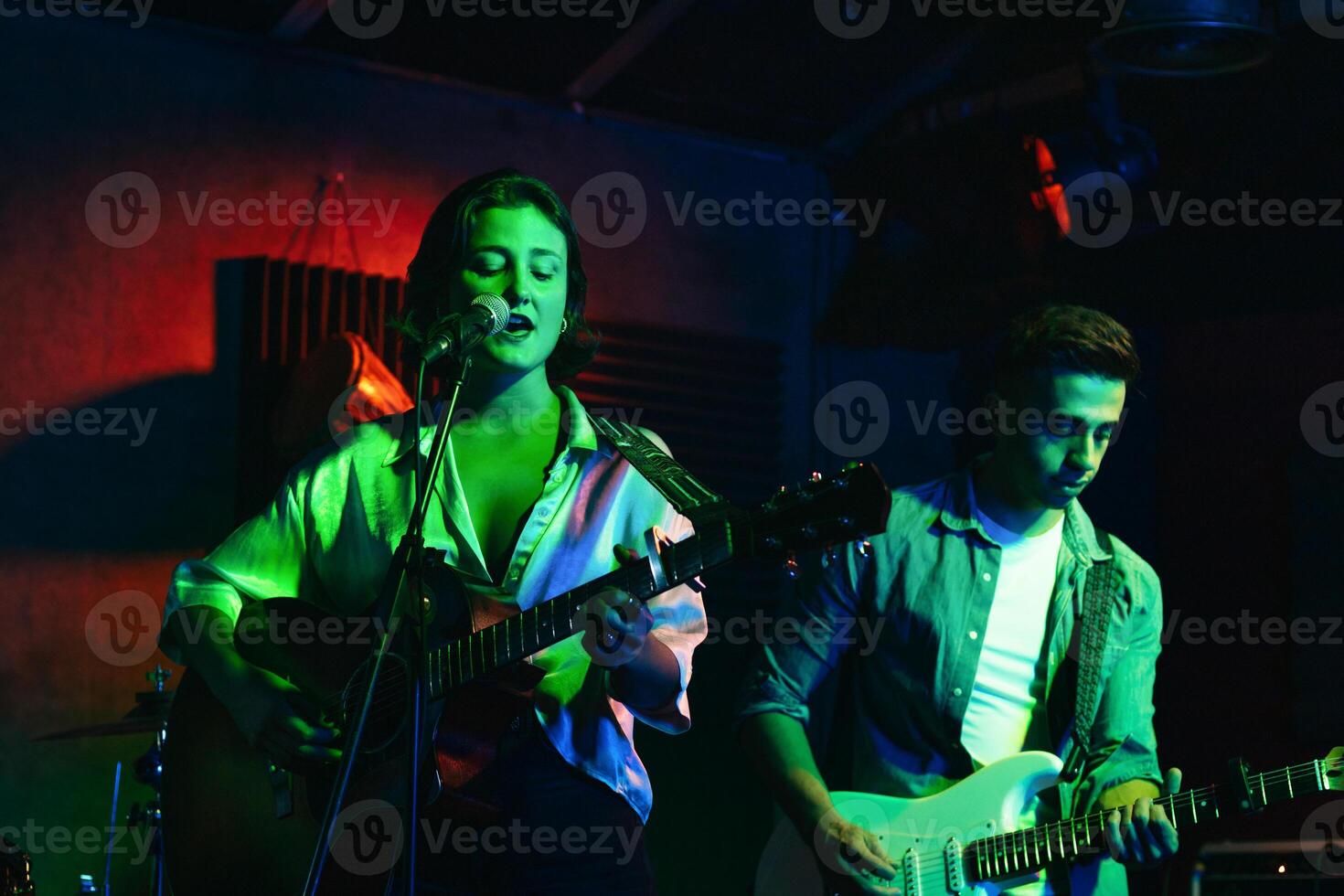 Musicians In Stage With Colorful Lights Performing In A Live Concert photo