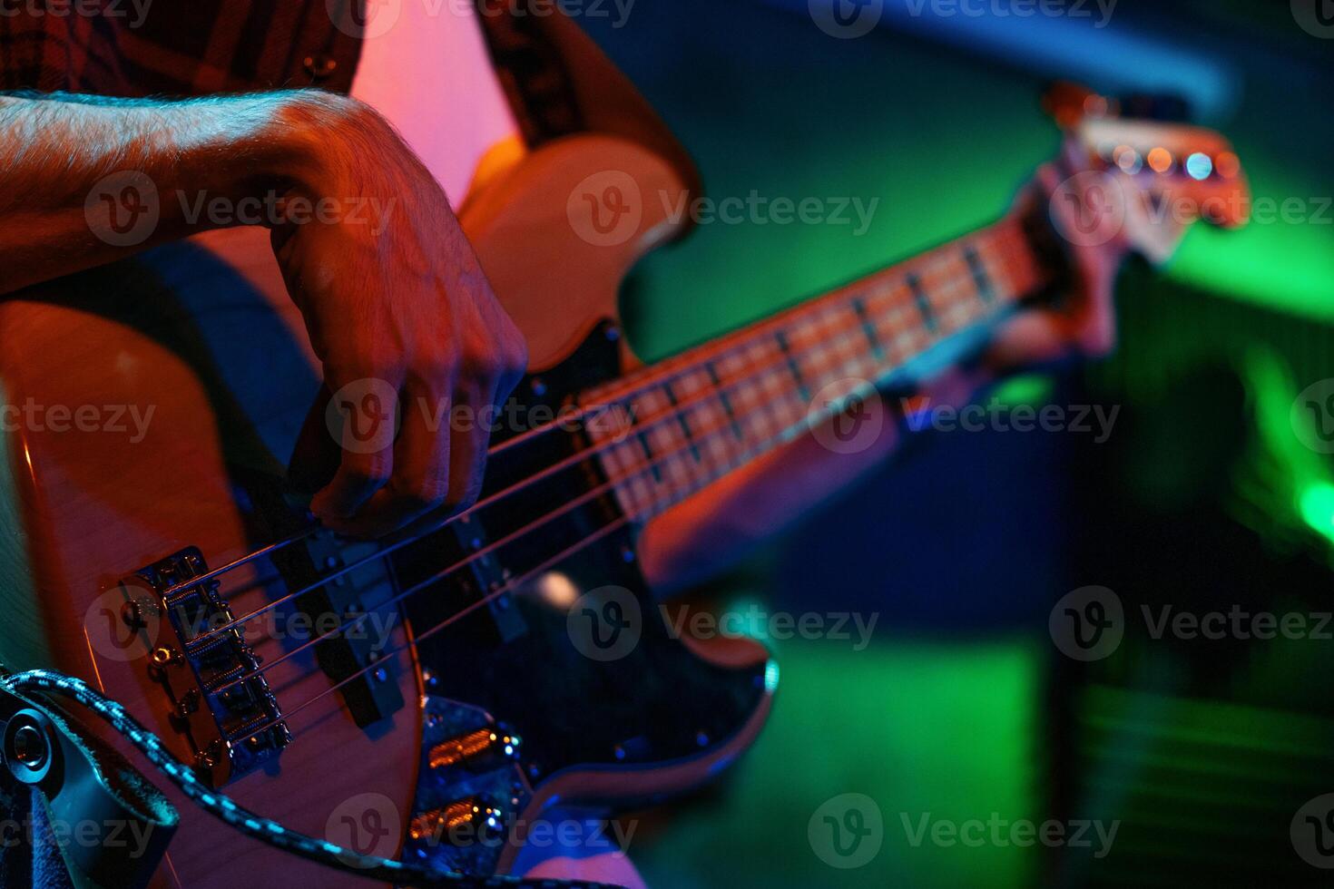Bass Player In Stage With Colorful Lights photo