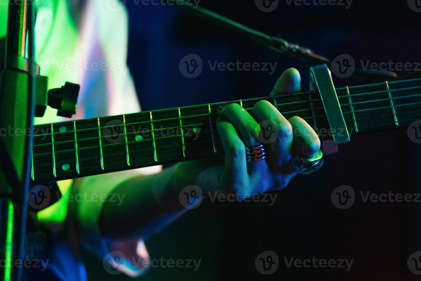 Musicians In Stage With Colorful Lights Performing In A Live Concert photo