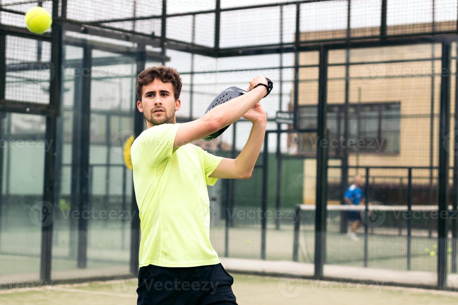 man playing paddle tennis. backhand photo
