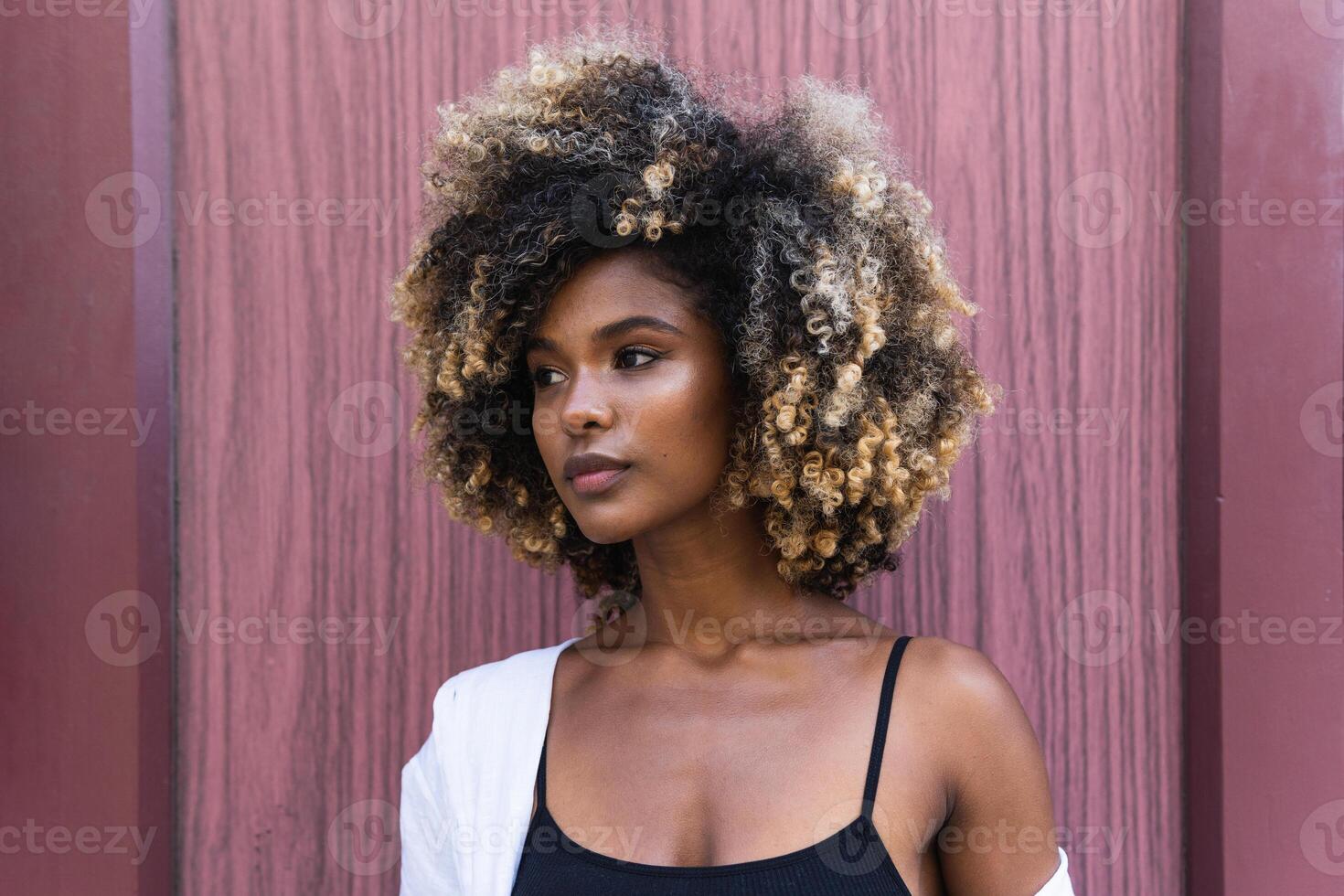 Stylish black woman standing near colorful door photo