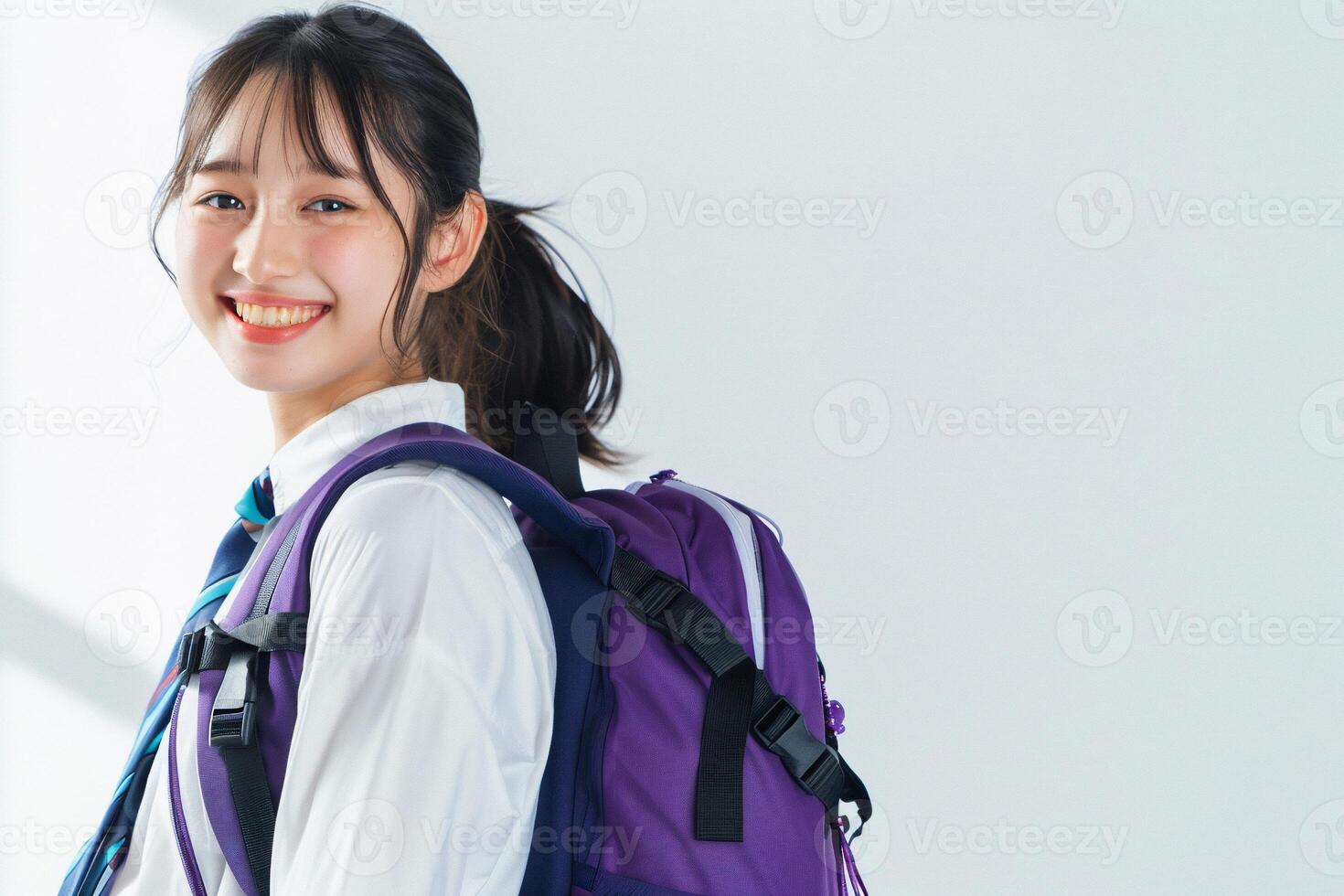Asian girl with backpack smiling photo