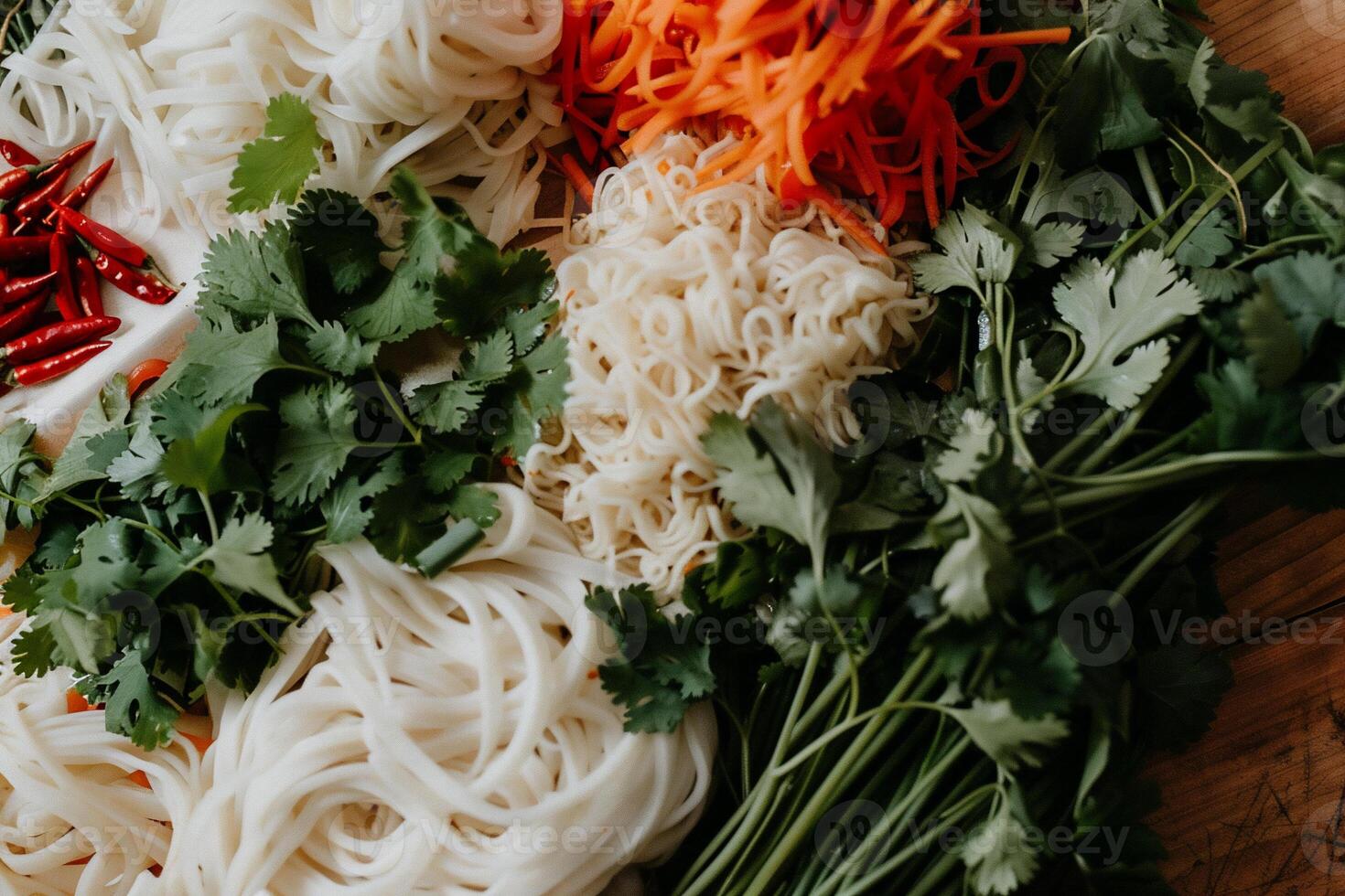 A bunch of noodles and vegetables on a table photo