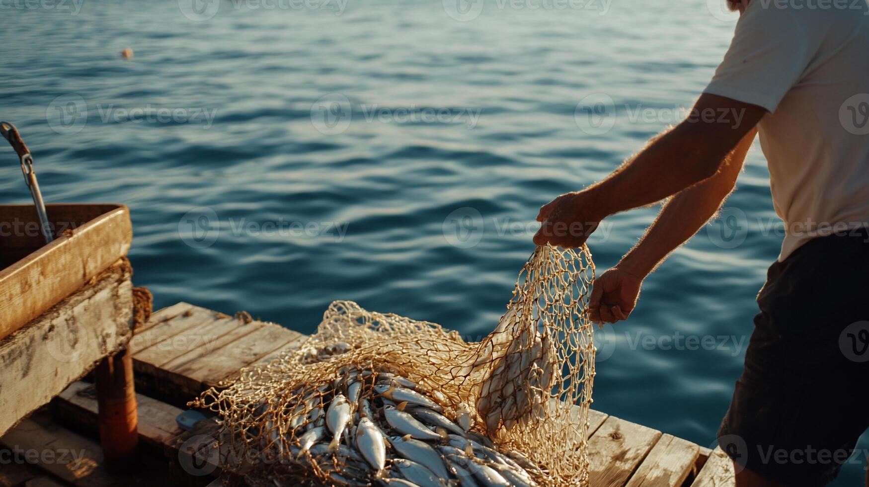 A man is holding a net full of fish photo