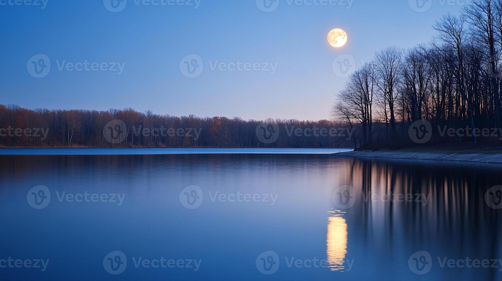 Serene lake at dusk, full moon reflecting photo