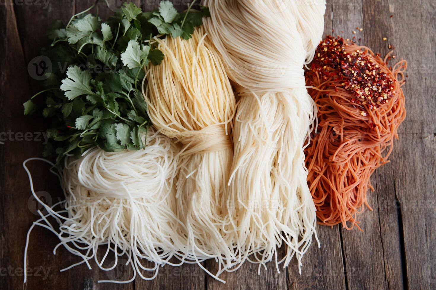 Assorted dried pasta and herbs on a rustic wooden surface photo