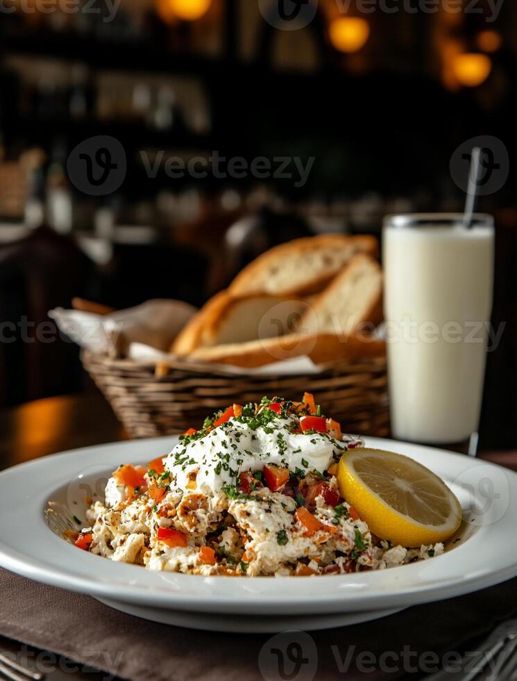 Delicious savory dish with yogurt sauce, vegetables, and lemon photo