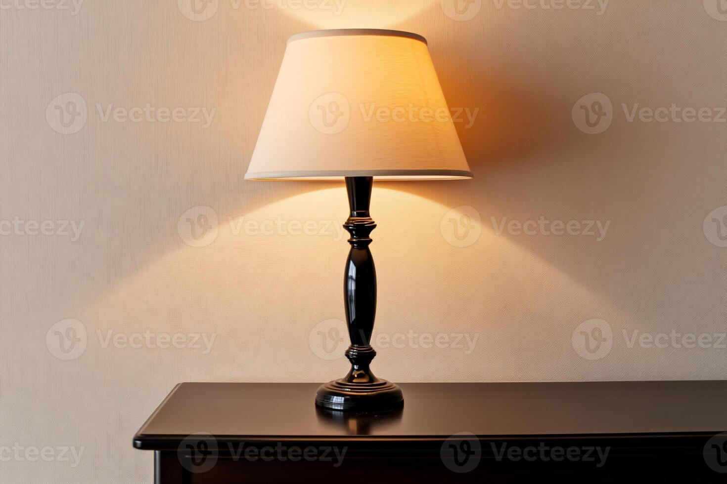 Table lamp casting warm light on a wall photo