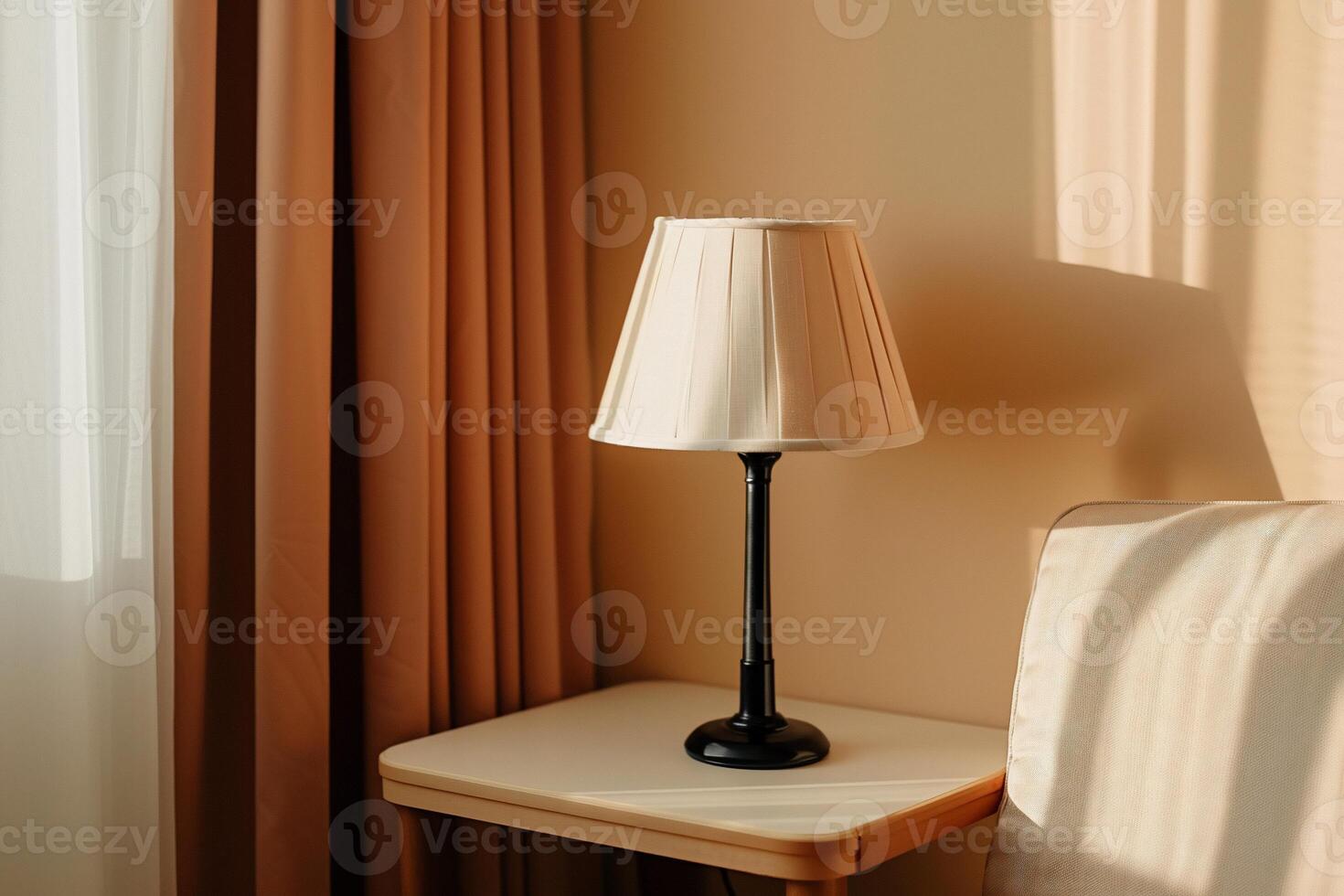 Warm sunlight illuminates a simple table lamp photo
