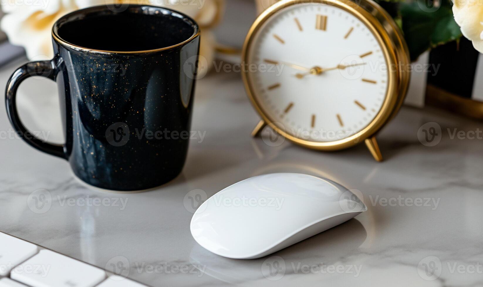 Modern workspace with coffee, clock, and mouse photo