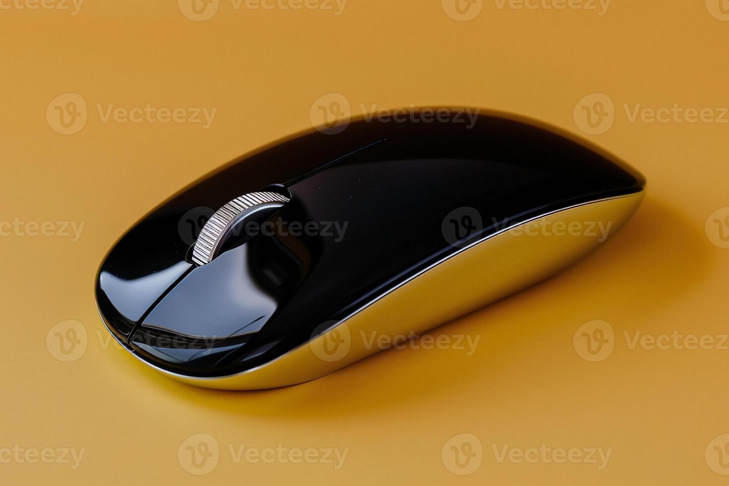 A black and gold computer mouse on a yellow background photo