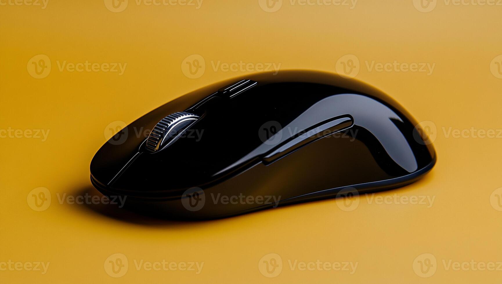Black wireless computer mouse on a yellow surface photo
