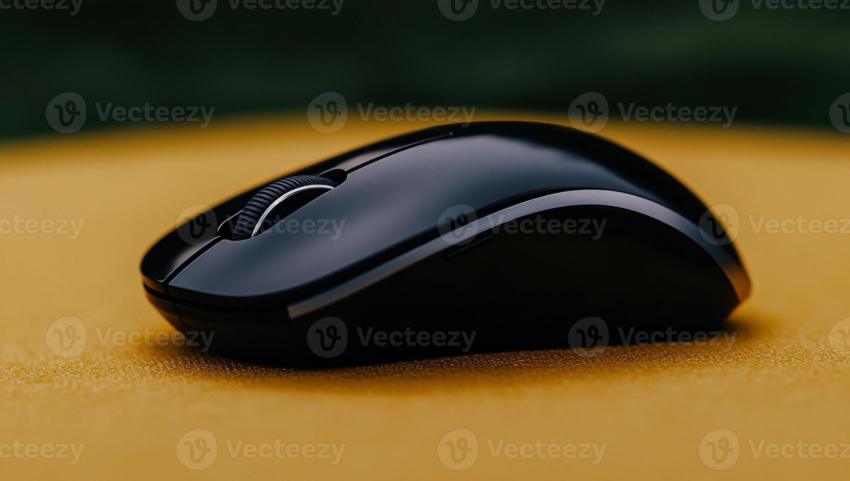 Sleek black wireless computer mouse on mustard yellow surface photo
