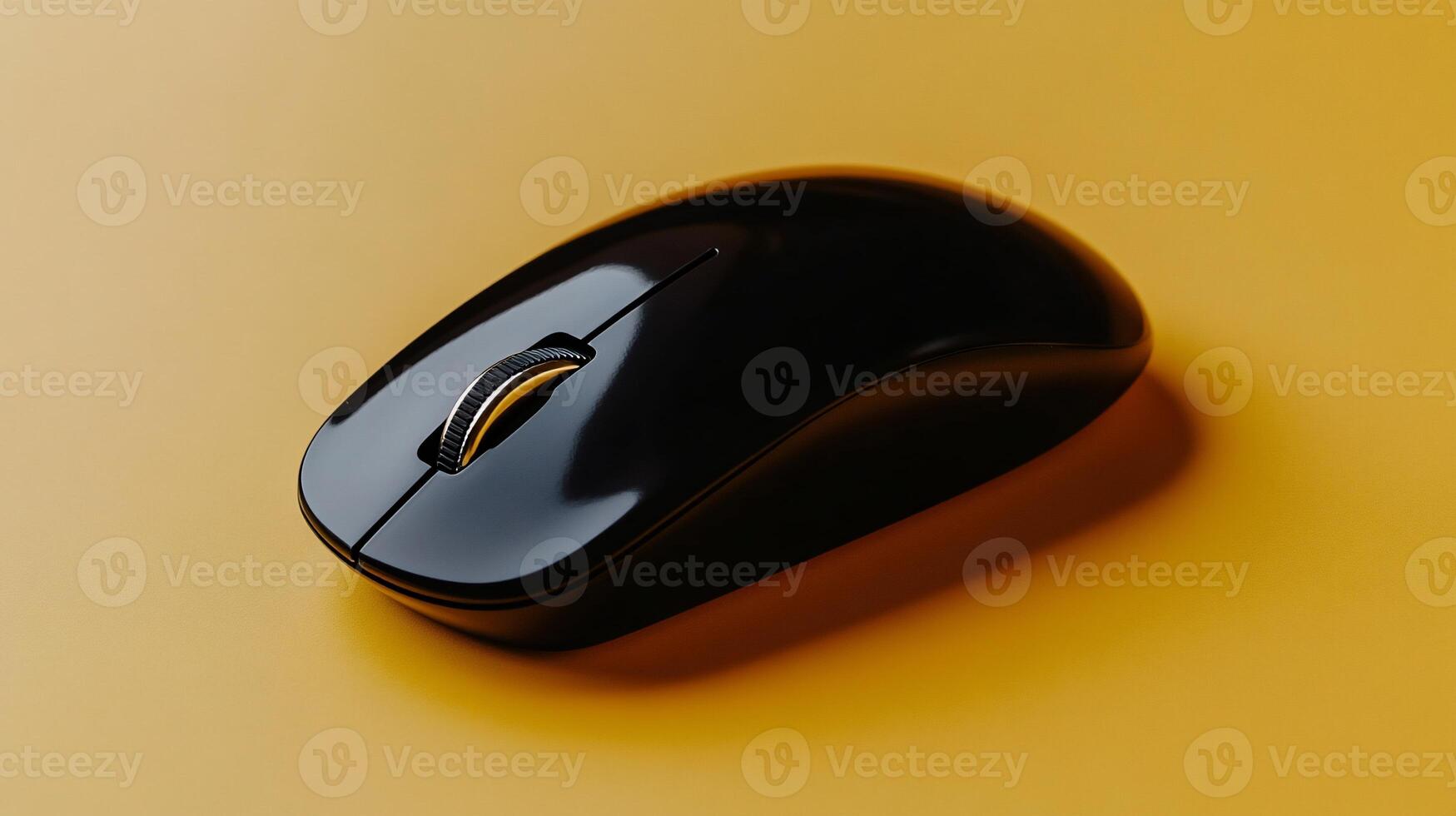 Black wireless computer mouse on a mustard yellow surface photo