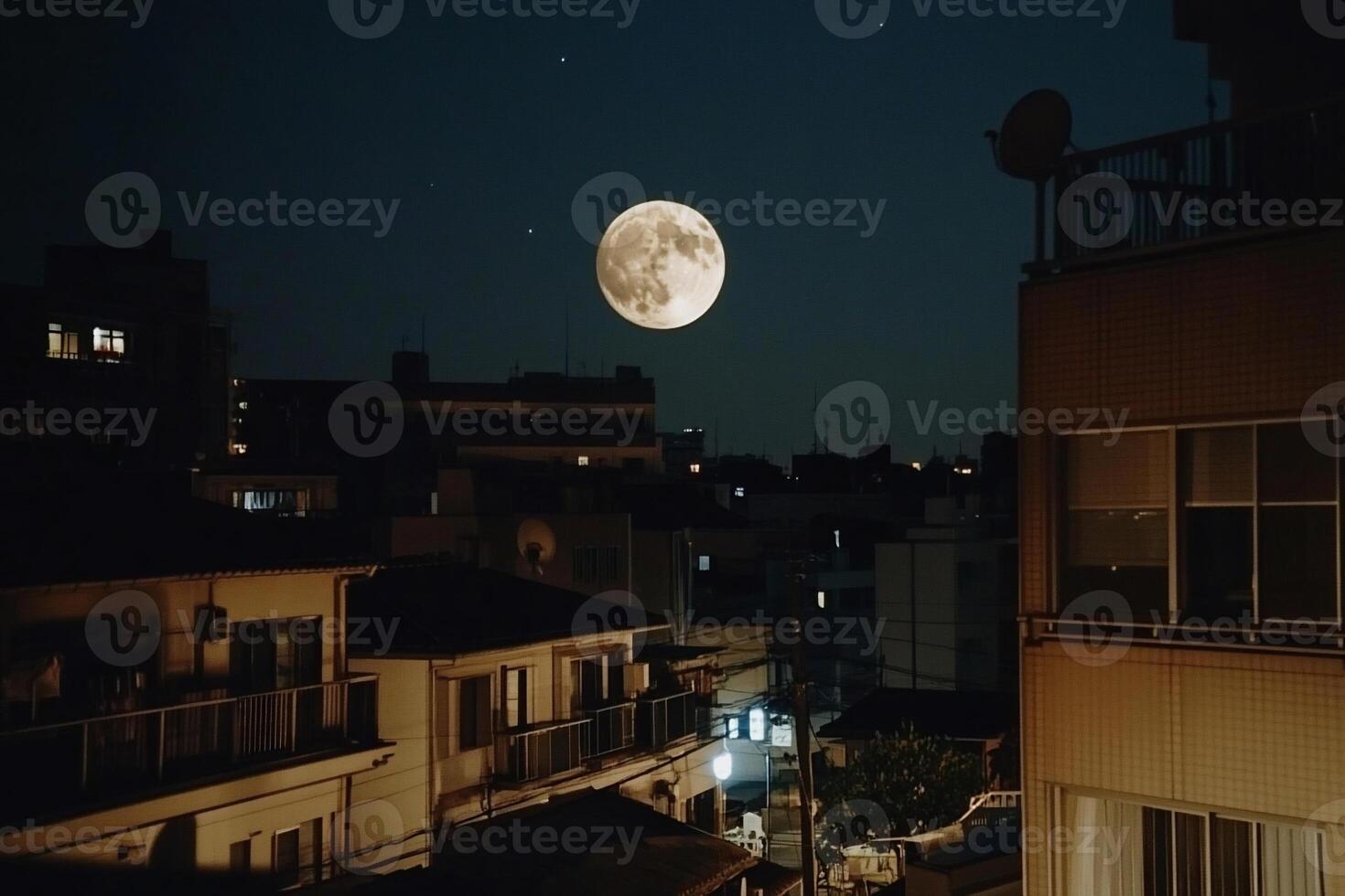 Full moon over city at night photo