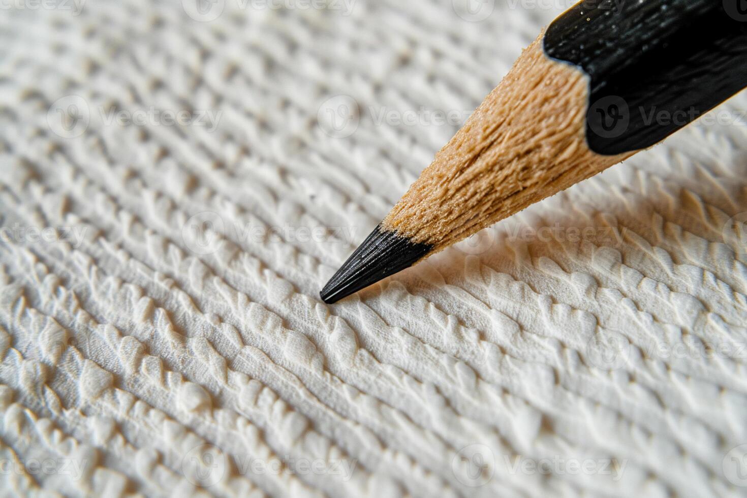 Close-up of graphite pencil on textured paper photo