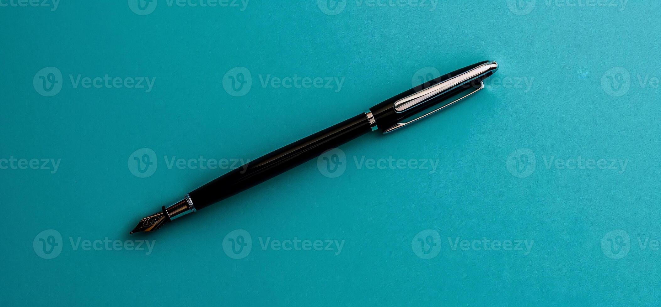 Black fountain pen on a turquoise background photo