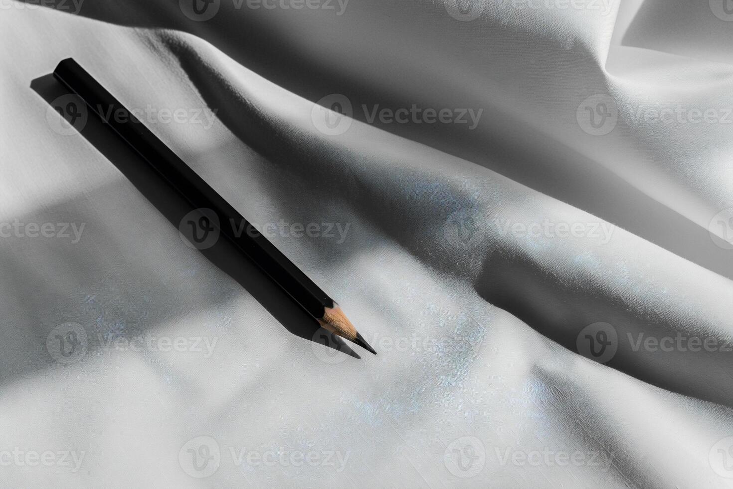 A black pencil on white fabric photo