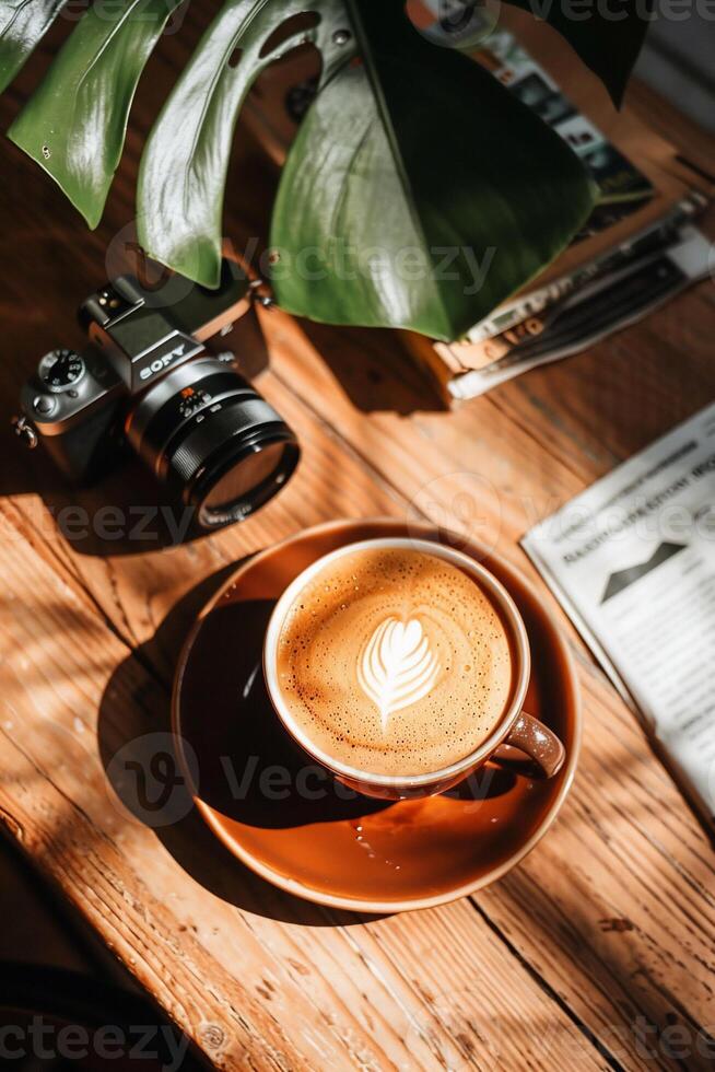Latte art, camera, and nature-inspired workspace photo