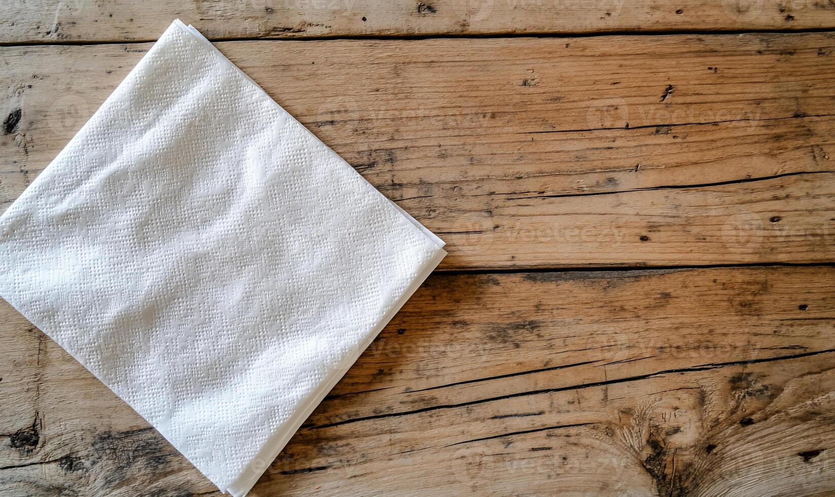 Folded white cloth on rustic wooden table photo