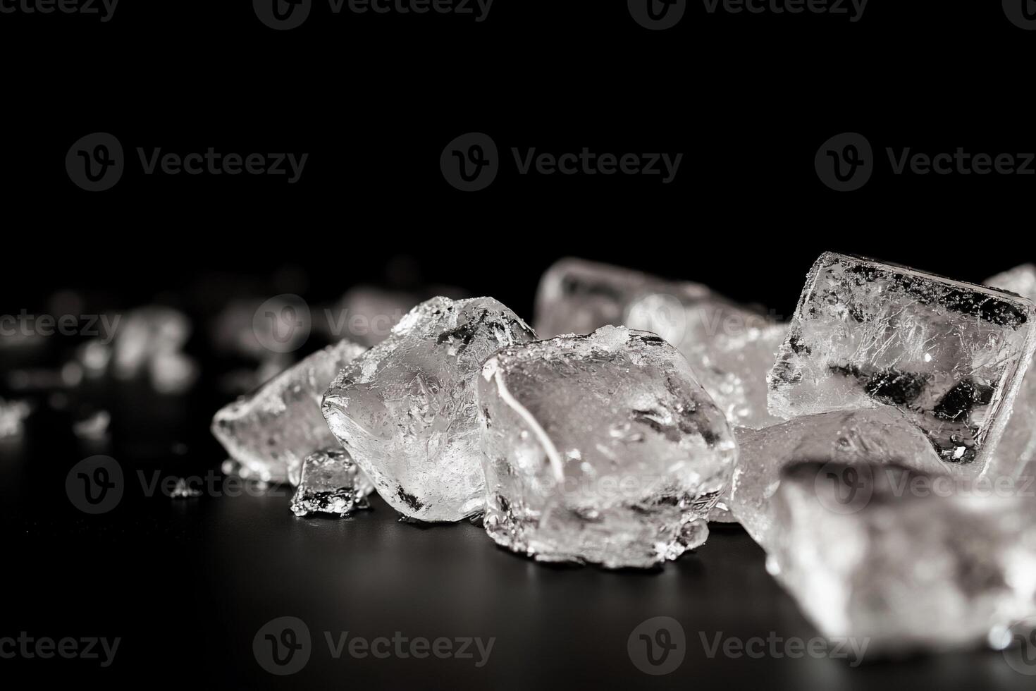 Close-up of ice cubes on a dark surface photo