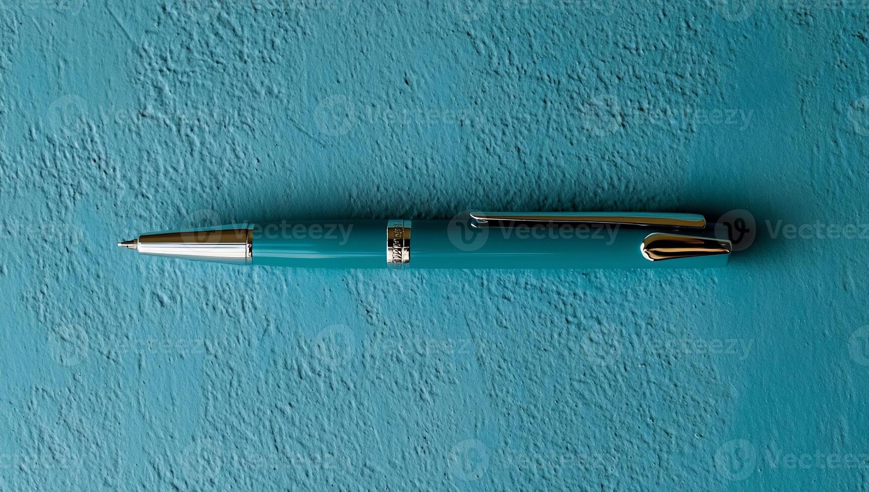 Teal ballpoint pen on teal surface photo