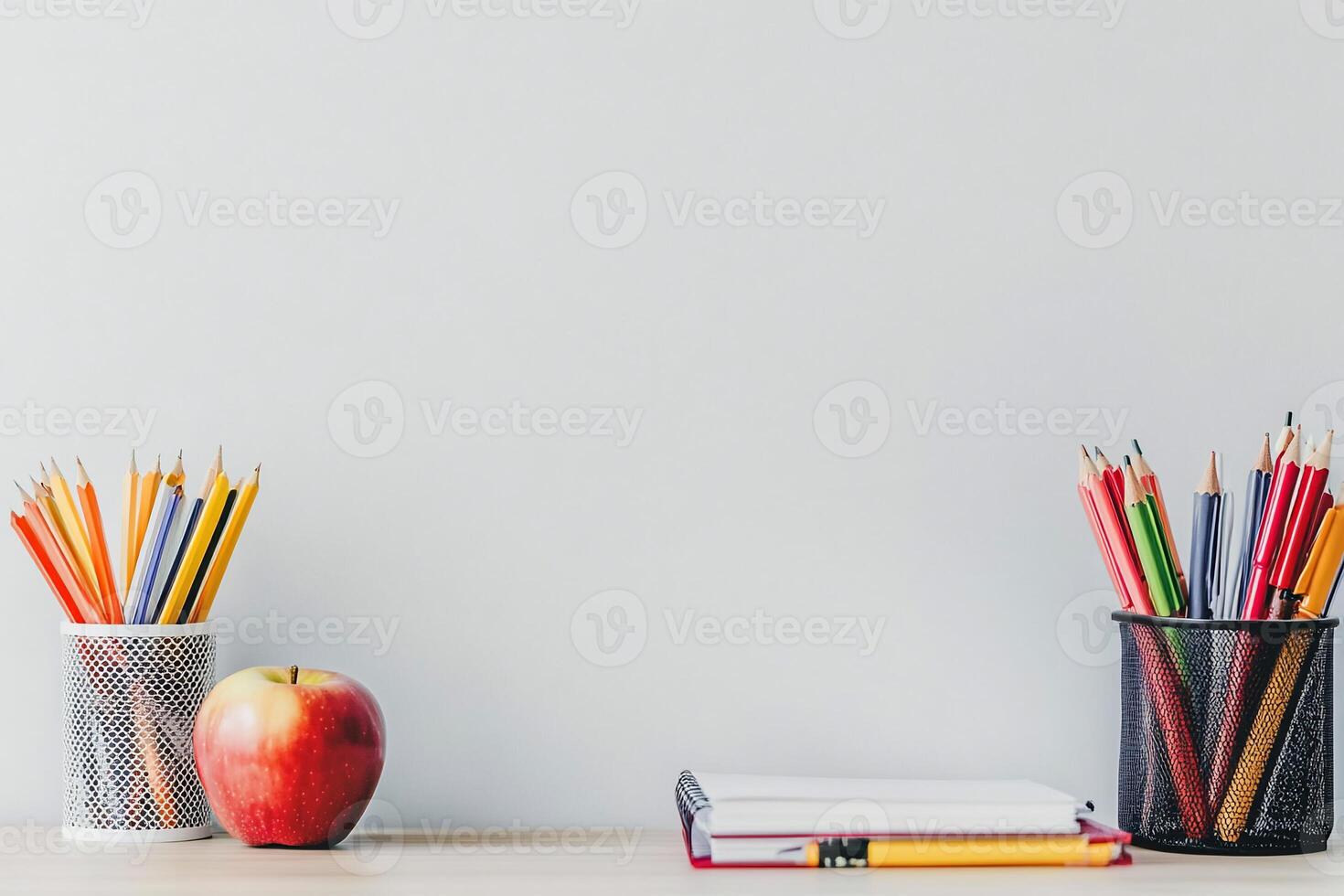 Back to school concept with pencils, notebook and apple on white table photo